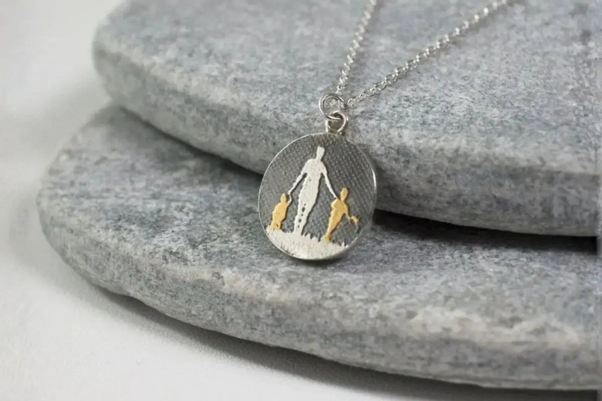 Mother and two children silhouette necklace capturing a meaningful family moment