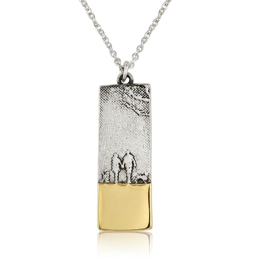 Sterling silver couple and two dogs necklace showing two figures walking with their dogs along the beach in silhouette.