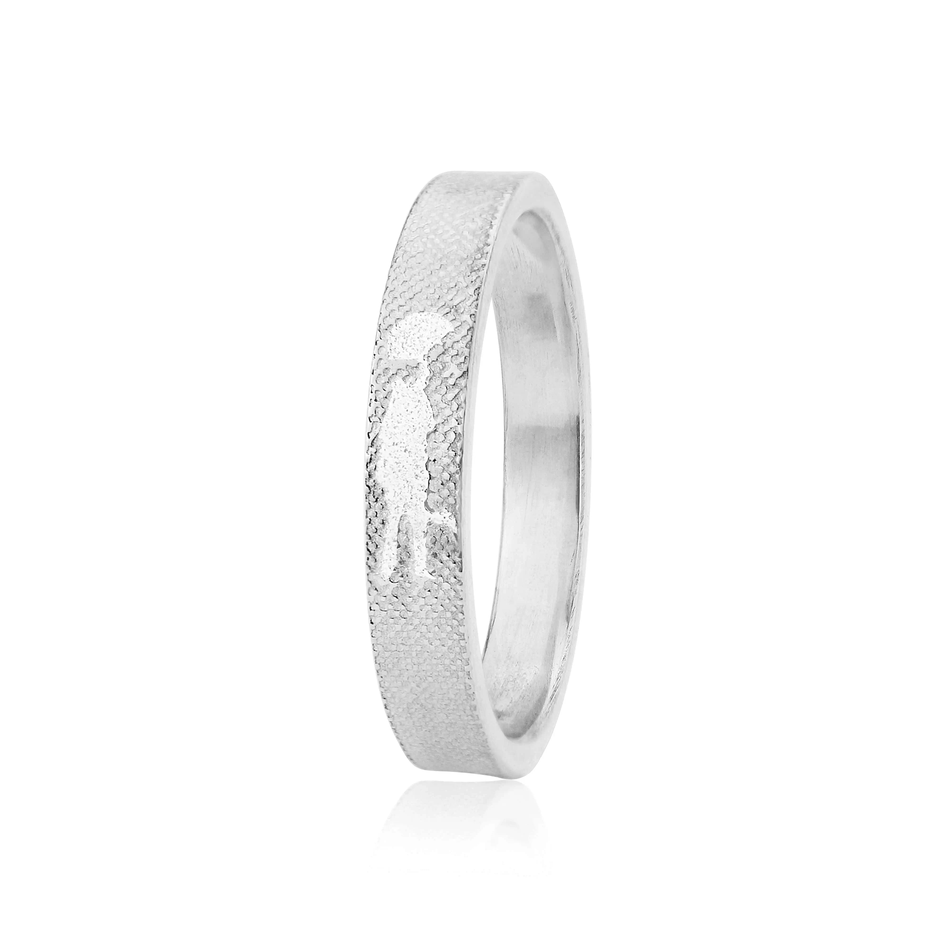 Unique wedding ring featuring couple embracing beneath umbrella etched into band