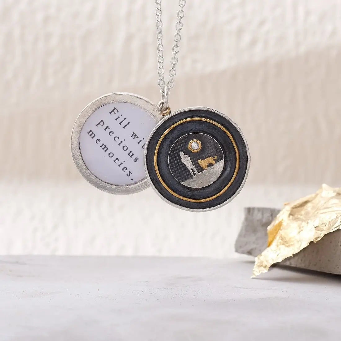 Dog Lovers Sapphire Moon Locket shown open in a lifestyle setting with etched dog silhouette and sapphire moon detail.