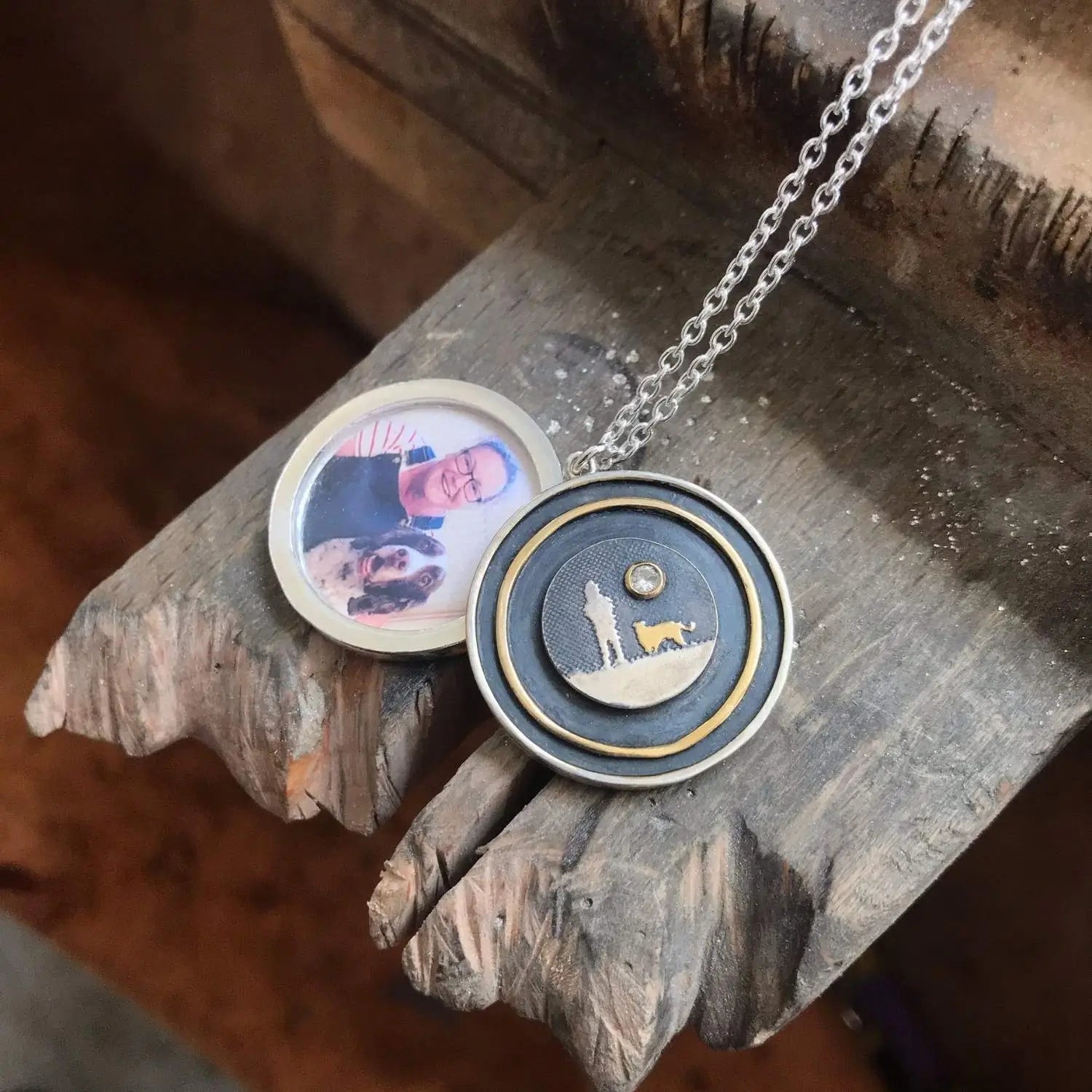 Dog Lovers Sapphire Moon Locket shown open on a jeweller’s bench with personalised photograph inside the frame.