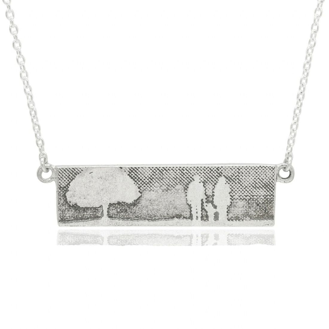 Family Tree Necklace showing a family of three beside a tree.