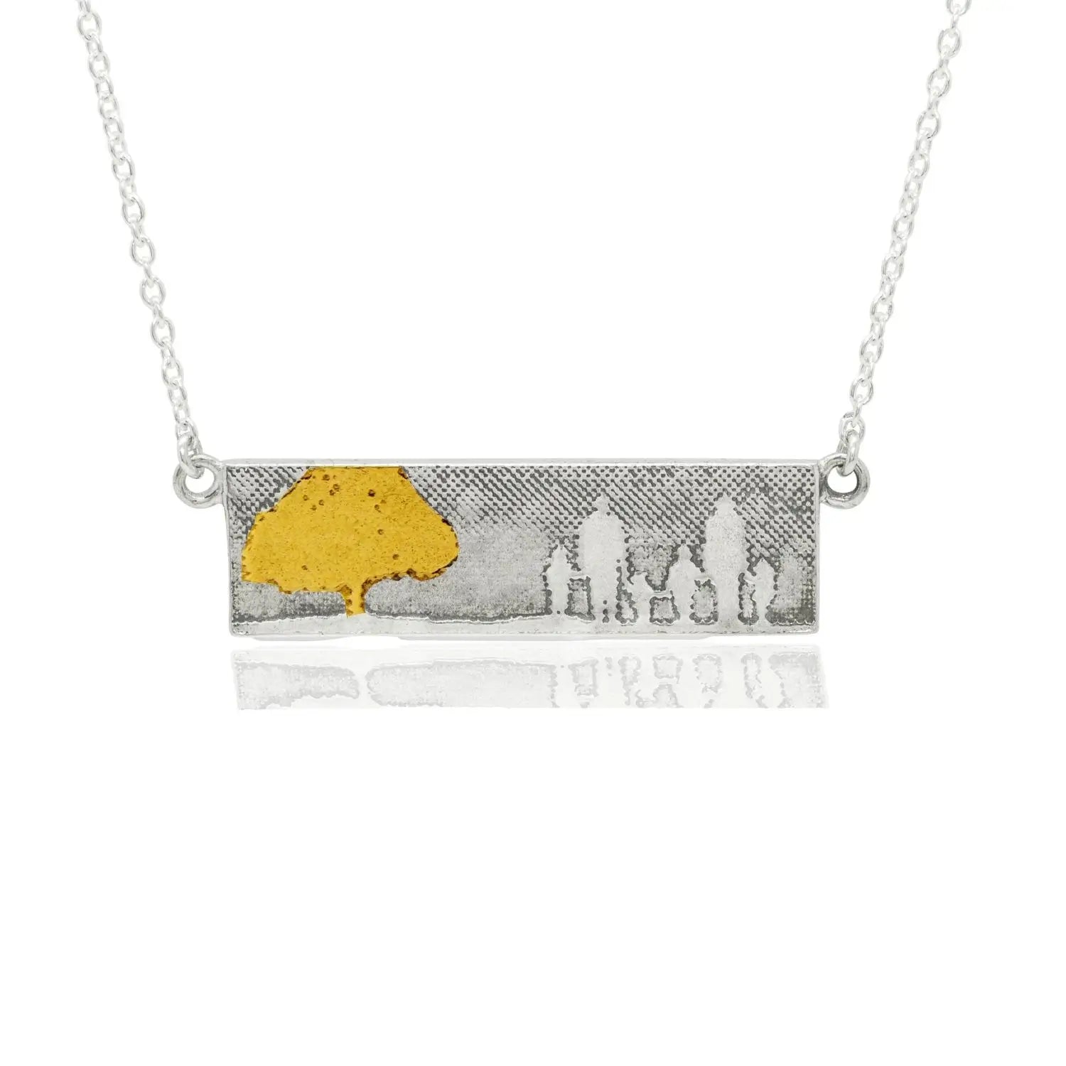 Family Tree Necklace with gold details showing a family of six beside a tree.