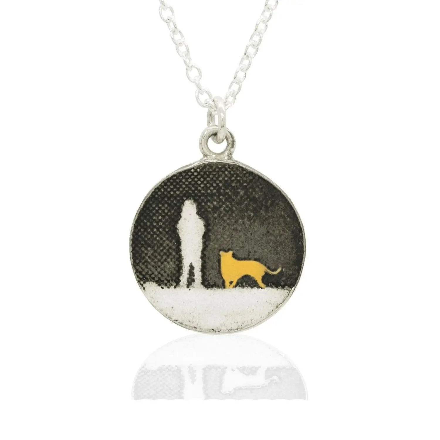 Sterling silver round dog necklace showing a person walking their dog under the night sky in silhouette with a gold‑vermeil dog.