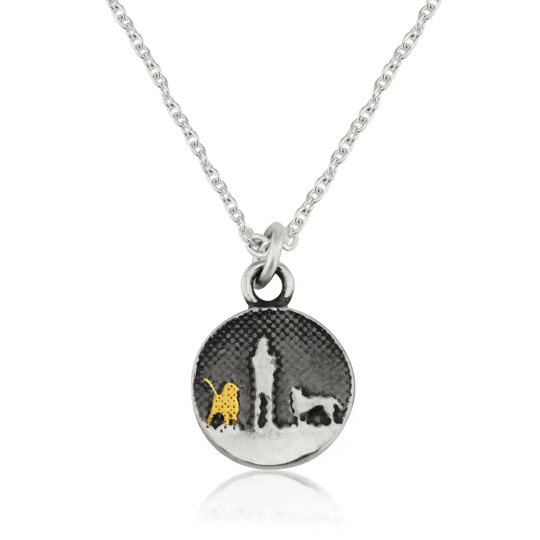 Walks Under Night’s Sky Dog Charm displayed on a silver chain, showing a small round charm etched with an owner and two dogs beneath an oxidised night sky, featuring one silver dog and one 22ct gold vermeil dog.