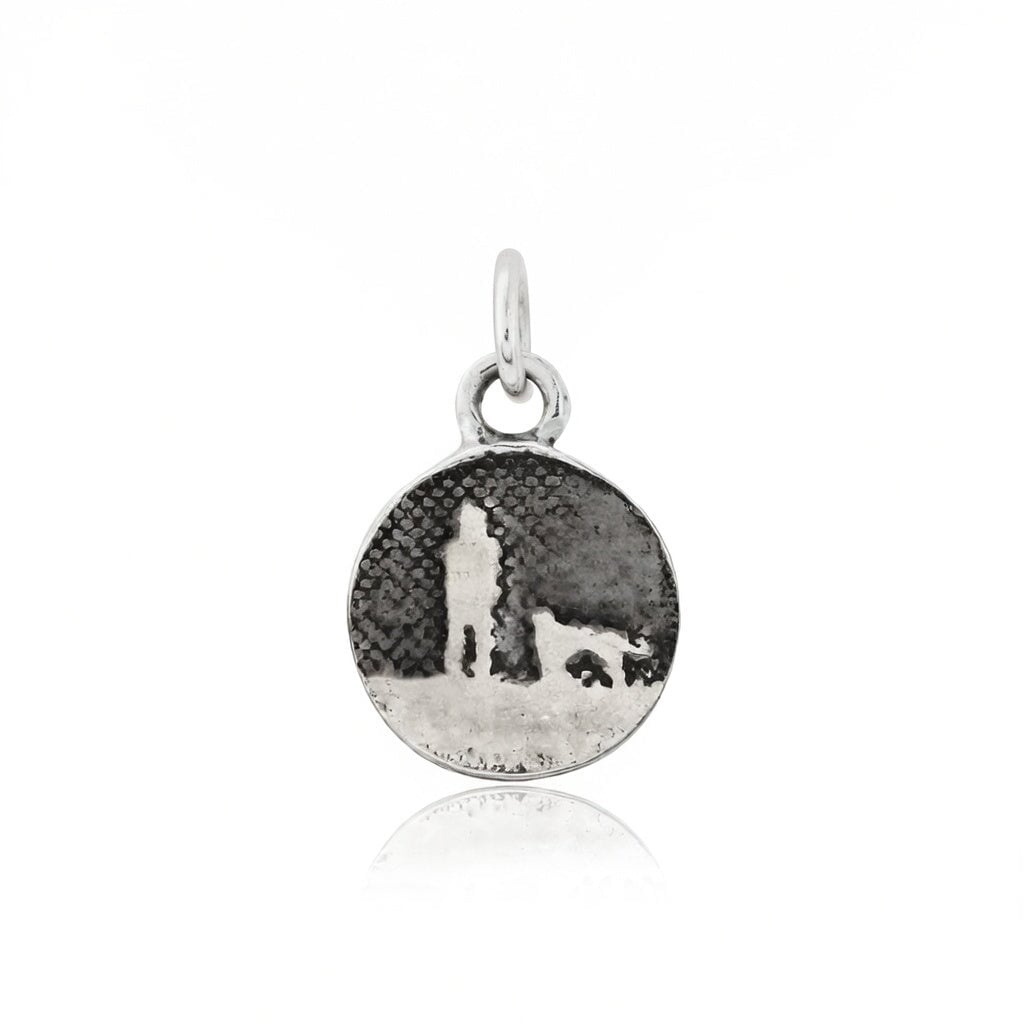 Walks Under Night’s Sky Silver Dog Charm showing a small sterling silver round charm etched with an owner and their dog beneath an oxidised night sky, featuring a single silver dog.