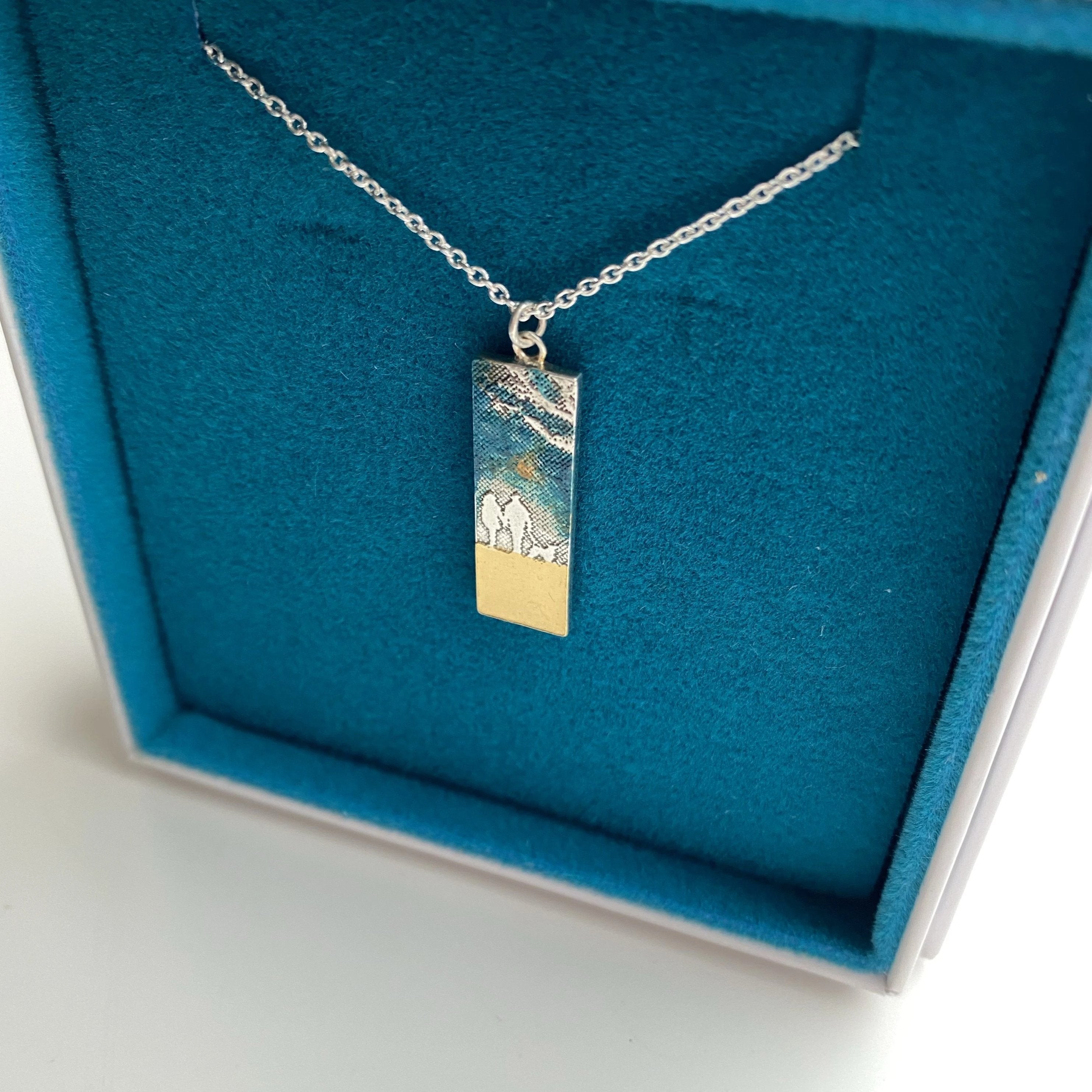 Beach Memory Couple & Dog Necklace with blue enamel sky baked onto the sterling silver silhouette design.