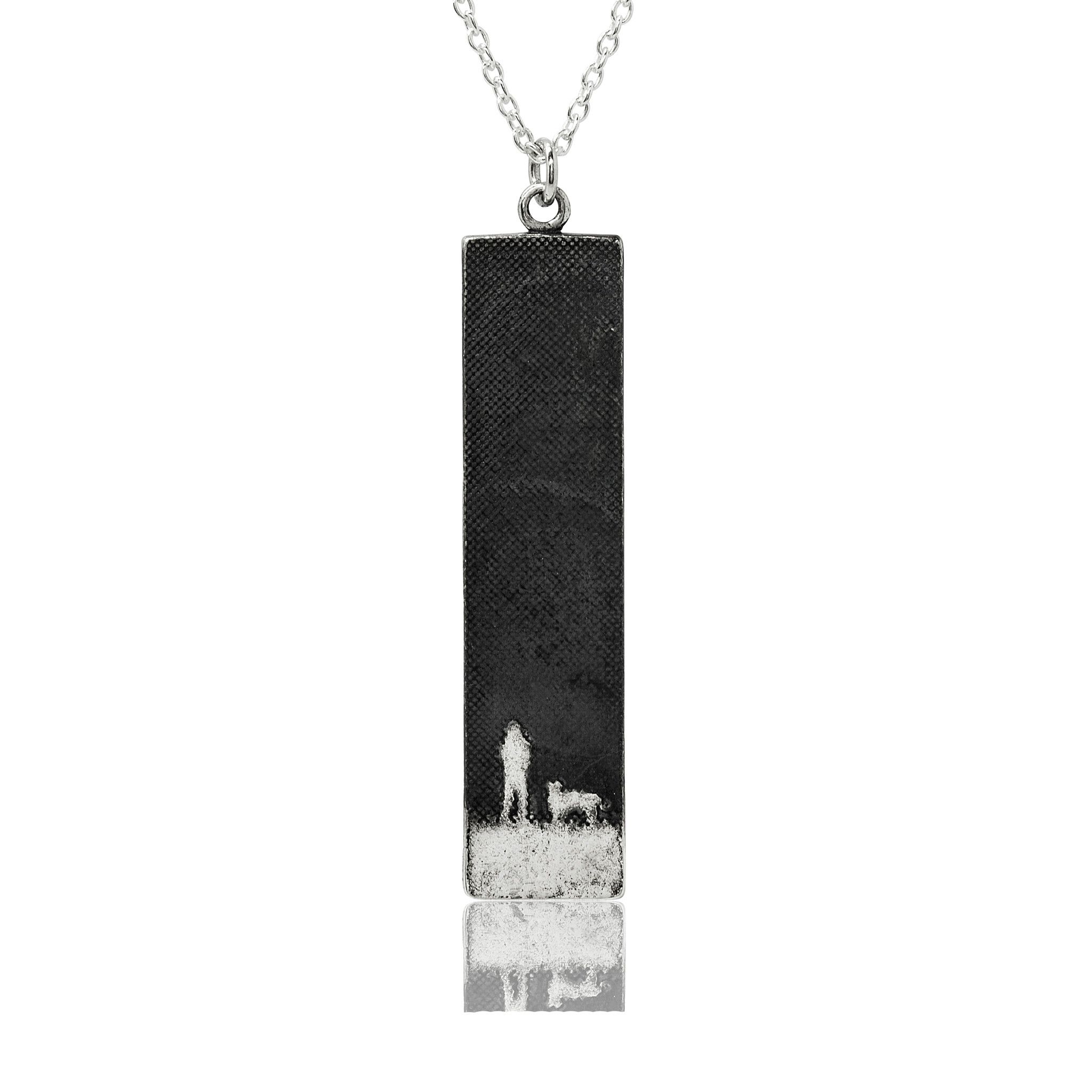 Large sterling silver dog lovers necklace with an etched owner and dog walking beneath a moonlit oxidised sky, shown in a rectangular silhouette.