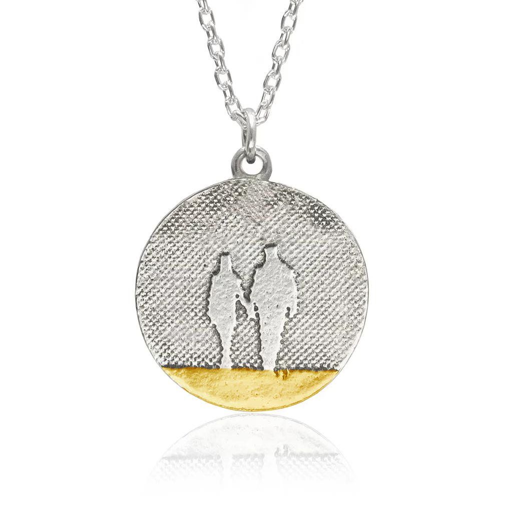 Round Beach Couple Necklace showing two figures enjoying a quiet moment together, etched into sterling silver with oxidised detail.