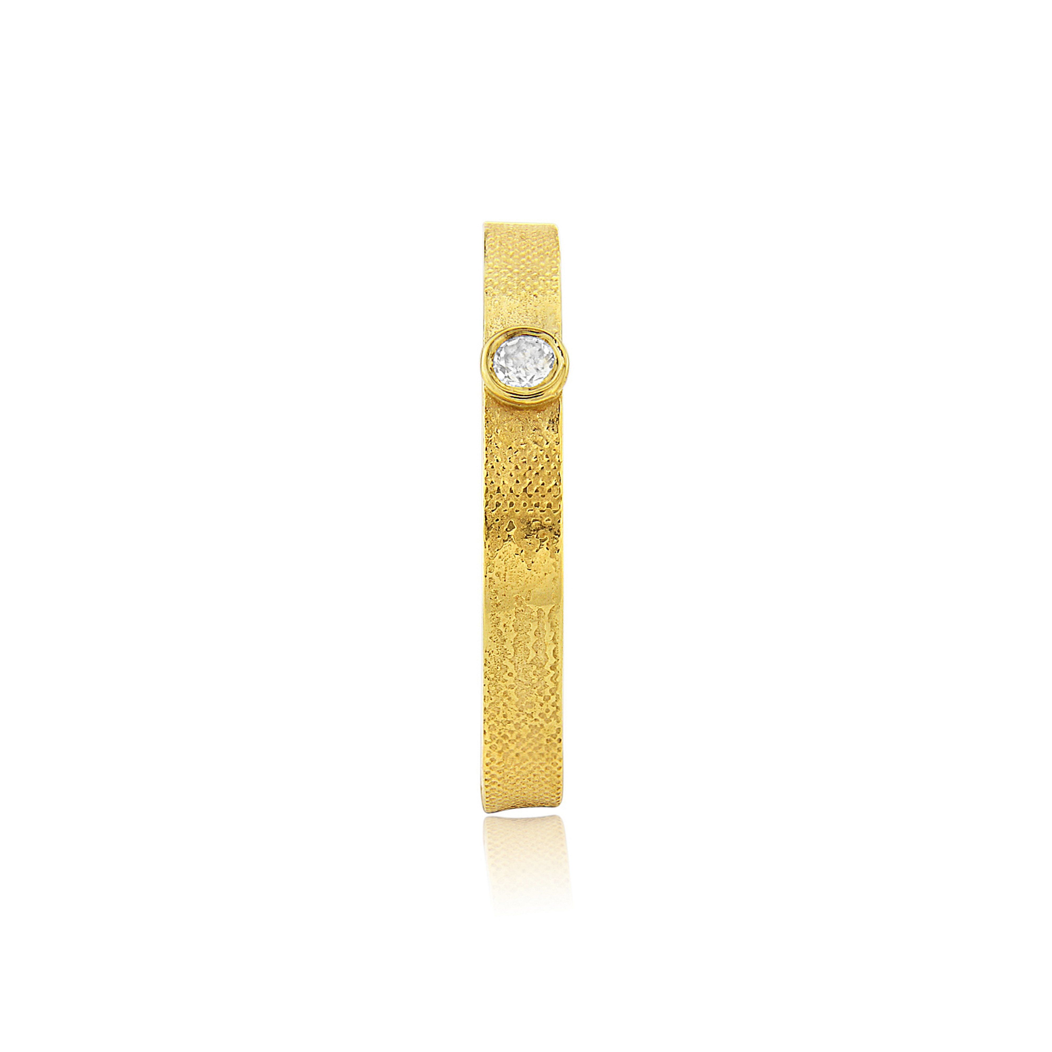 Handmade gold wedding ring featuring couple watching the sunset with diamond sun.