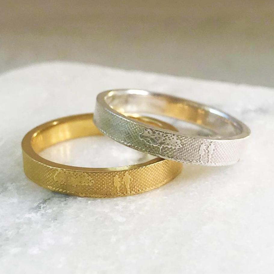 Unique wedding rings handmade in gold and platinum with silhouette artwork by Charlotte Lowe.