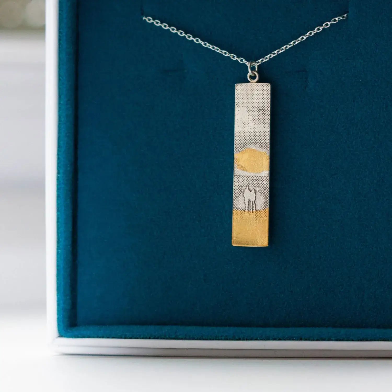 Sunset couple necklace presented in a blue and white Charlotte Lowe gift box.