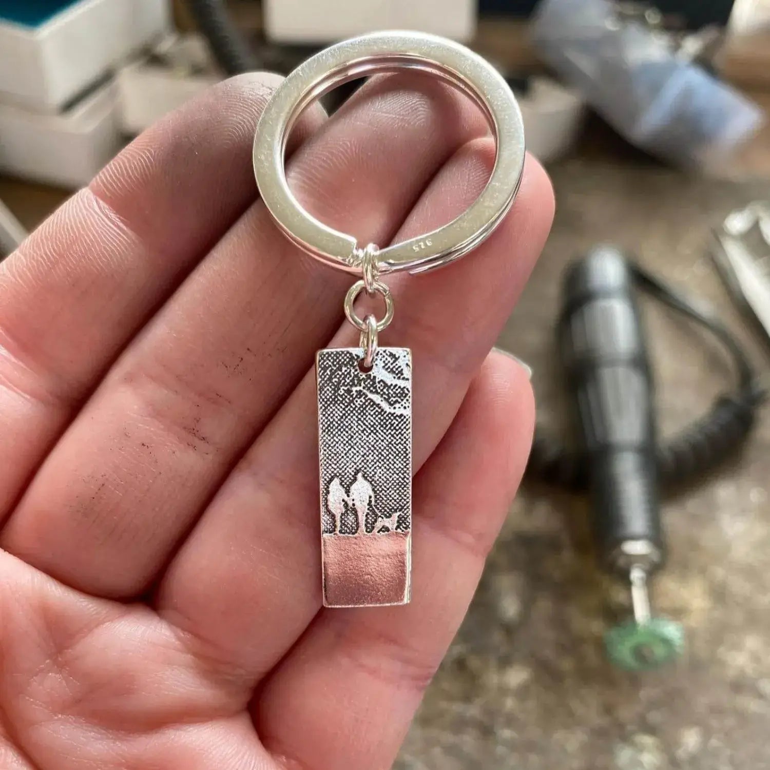 Couple & Mans Best Friend Silver Dog Keyring in makes hand.