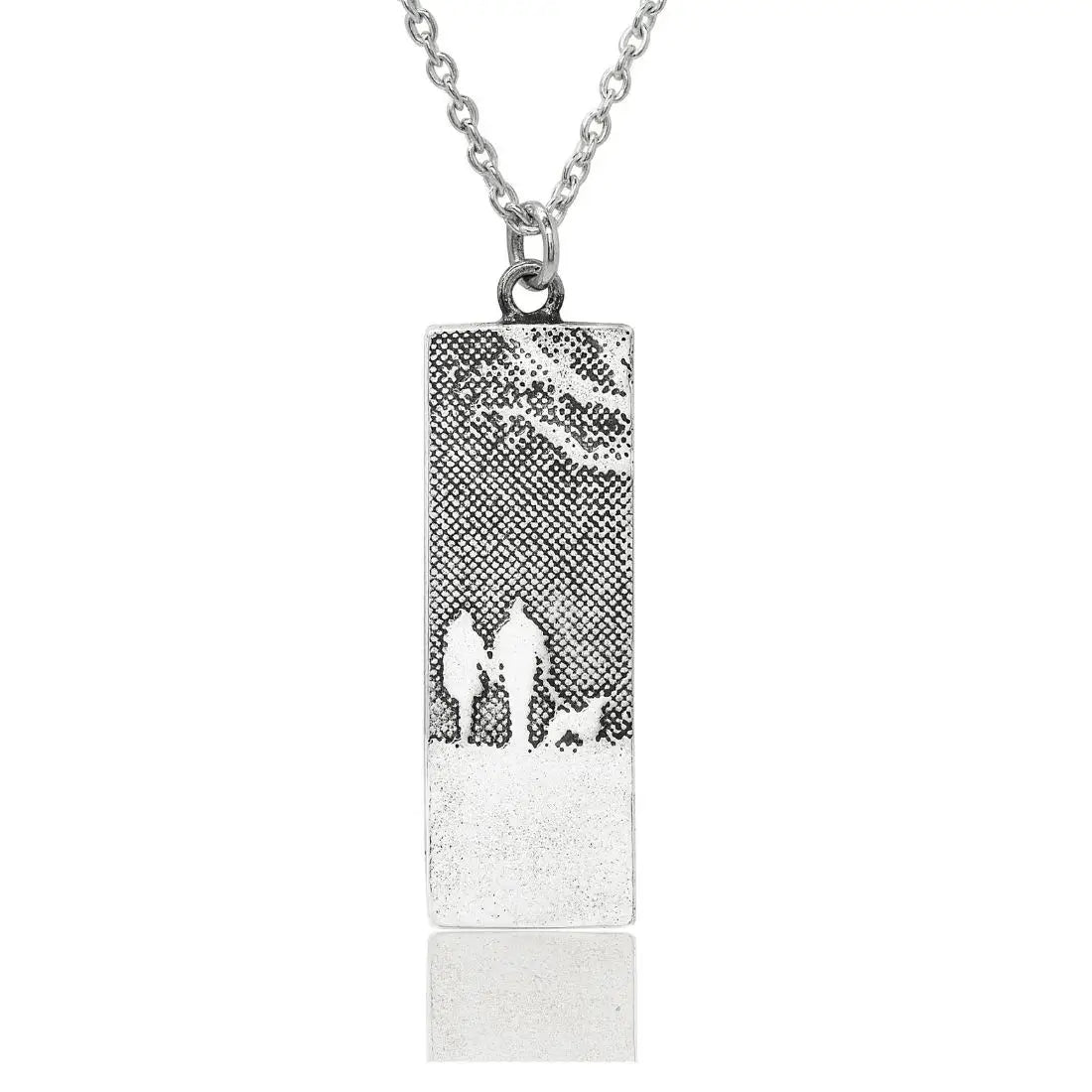 Sterling silver couple and dog necklace showing two figures walking with their dog in silhouette.