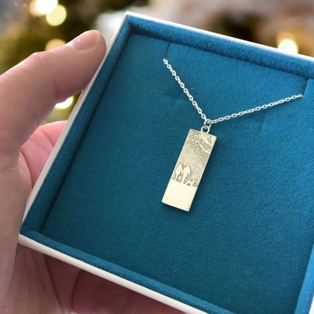 Couple & Man’s Best Friend Silver Dog Necklace showing the sterling silver silhouette pendant in blue and white box.