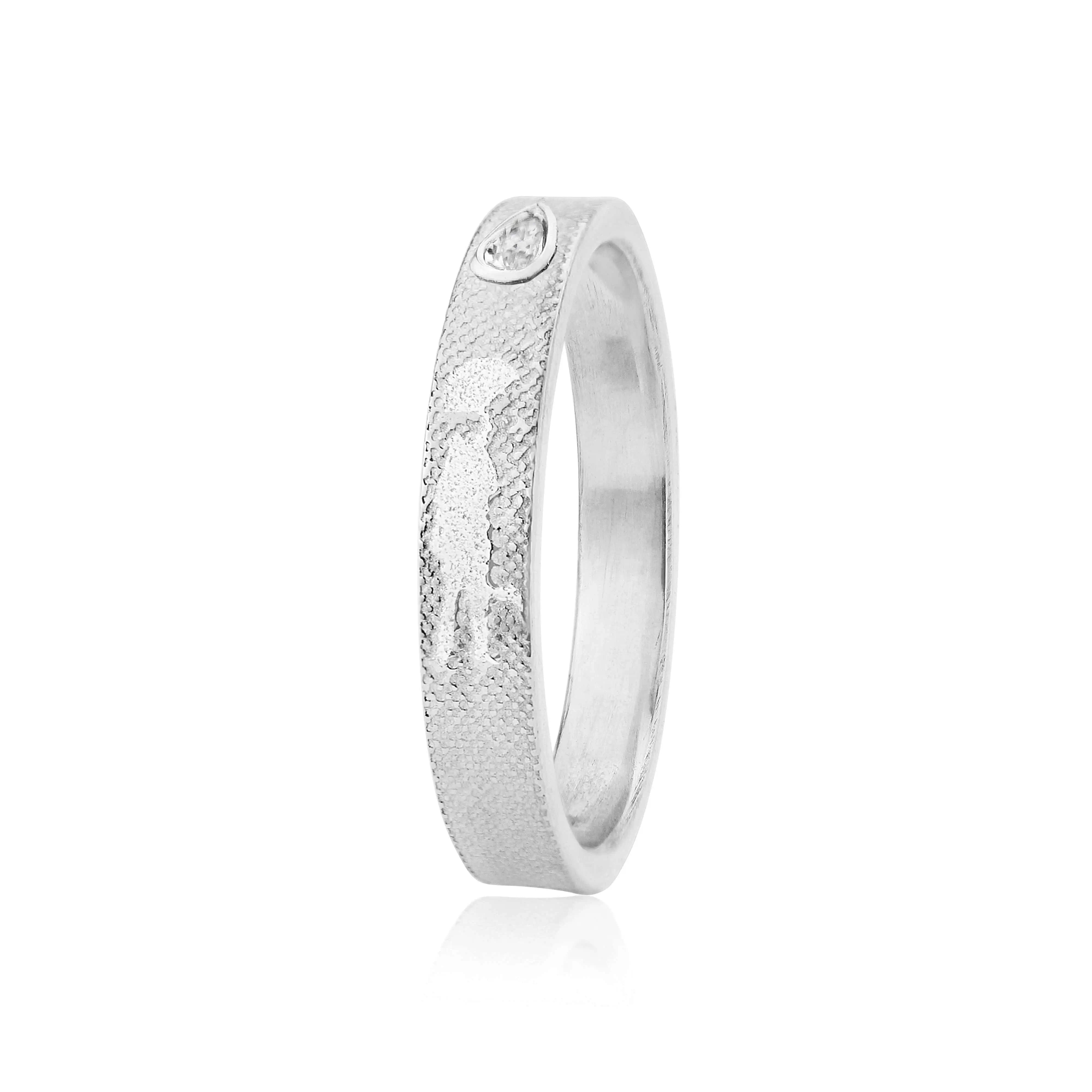 White gold Dancing in the Rain diamond wedding ring with pear‑shaped diamond by Charlotte Lowe.