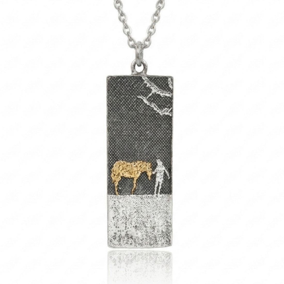 Golden horse lovers necklace in sterling silver with oxidised nights sky with etched figures of golden horse and polished silver owner.