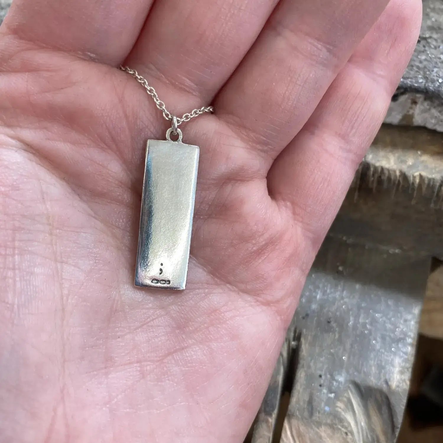 Mental health awareness engraving on back of pendant. 