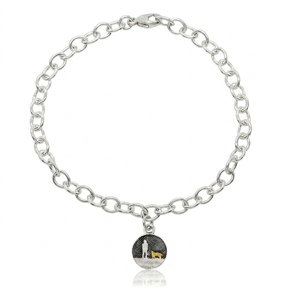 Sterling silver bracelet with a moonlit night sky charm showing an owner walking with two dogs, one highlighted in gold.