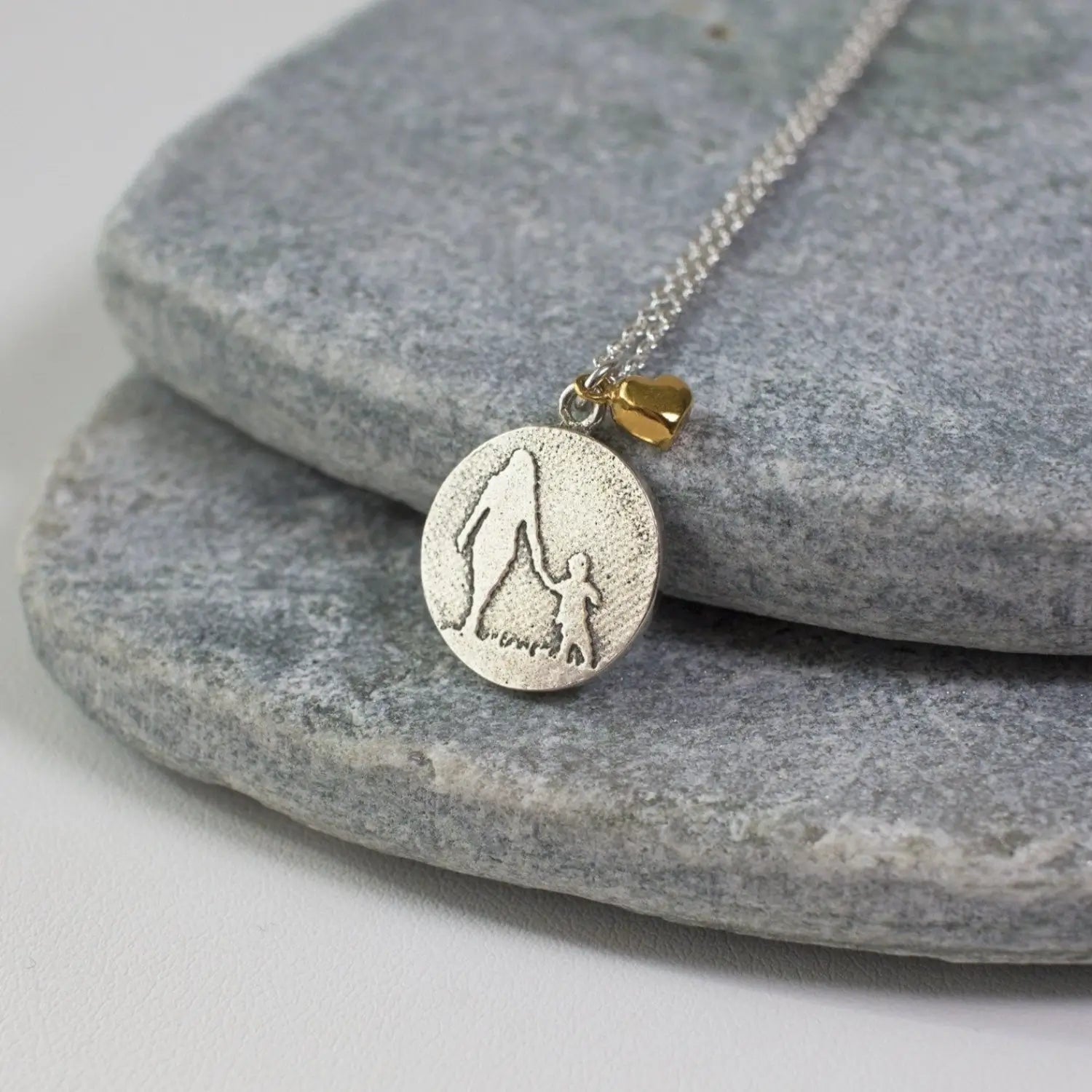 mother and child round necklace in sterling silver with golden heart charm