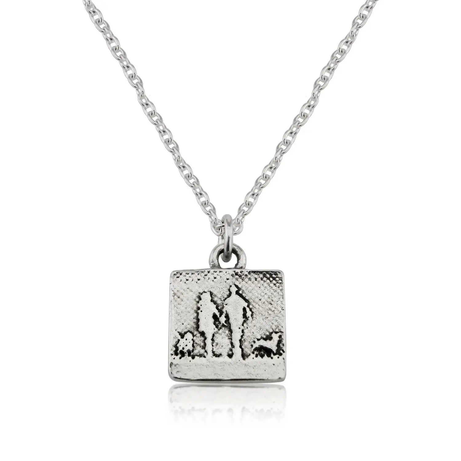 Small sterling silver couple and two dogs necklace showing an etched silhouette of two figures walking with their dogs.
