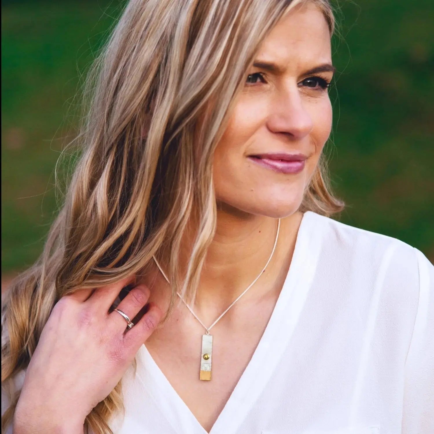 Model wearing the sunset couple necklace with yellow sapphire centre.