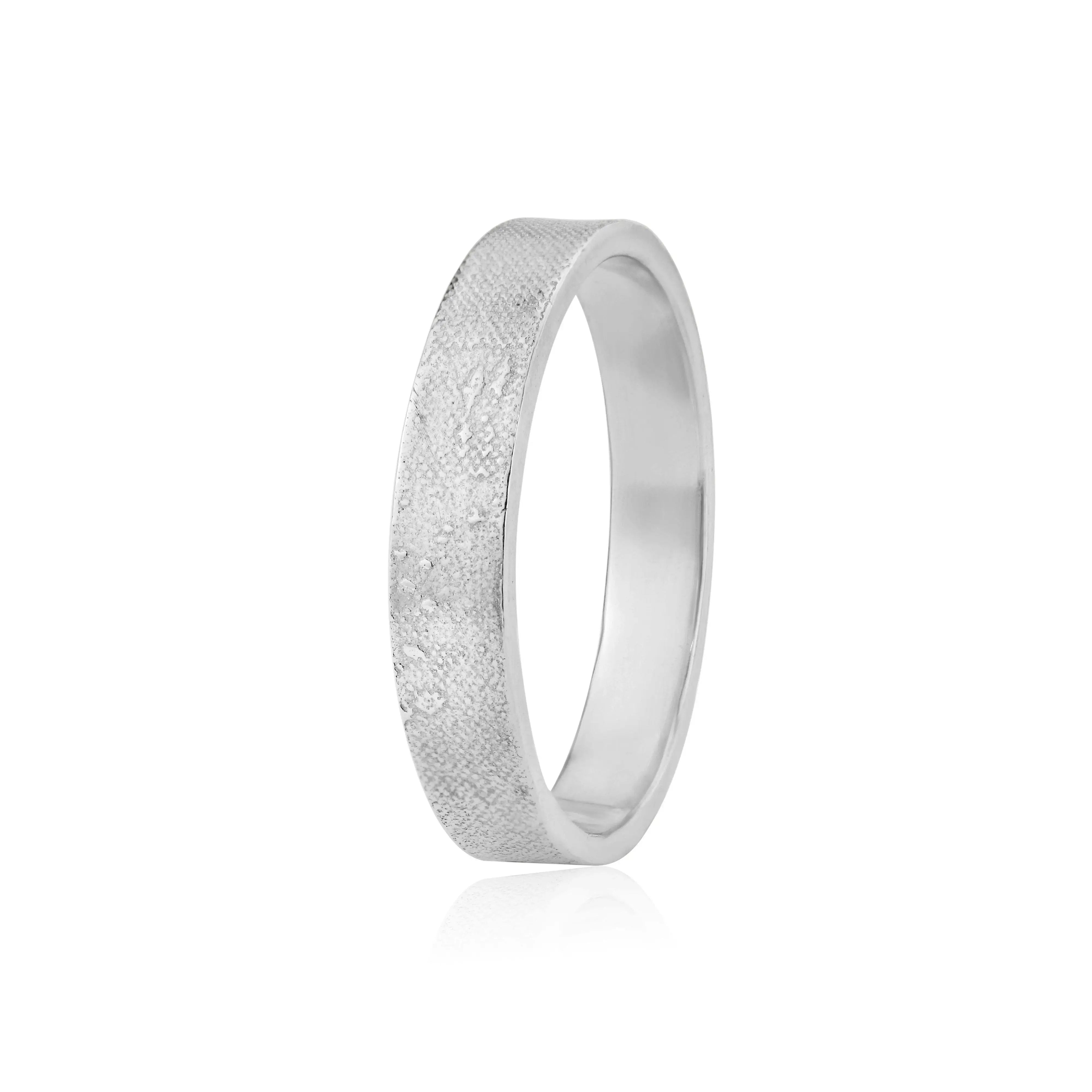 Unique wedding ring featuring couple walking along the sand etched into band in white gold
