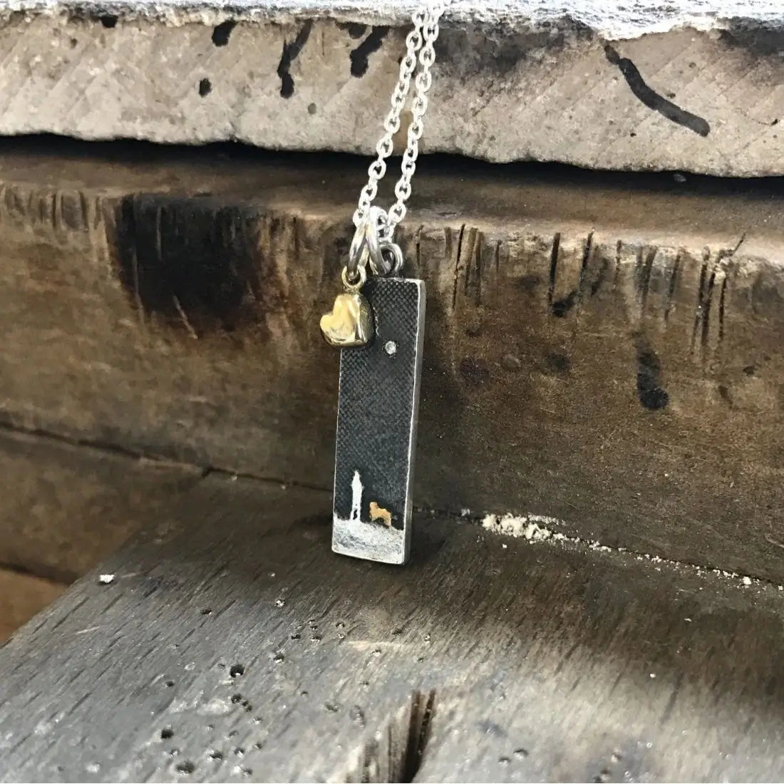 Detail of the Walks Under the Moonlit Sky Small Dog Necklace showing the etched dog silhouette and diamond star in the night sky.