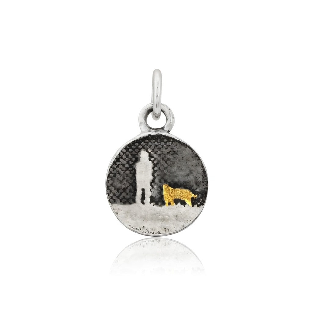 Walks Under Night’s Sky Gold Dog Charm showing a small sterling silver round charm etched with an owner and their dog beneath an oxidised night sky, featuring a single 22ct gold vermeil dog.
