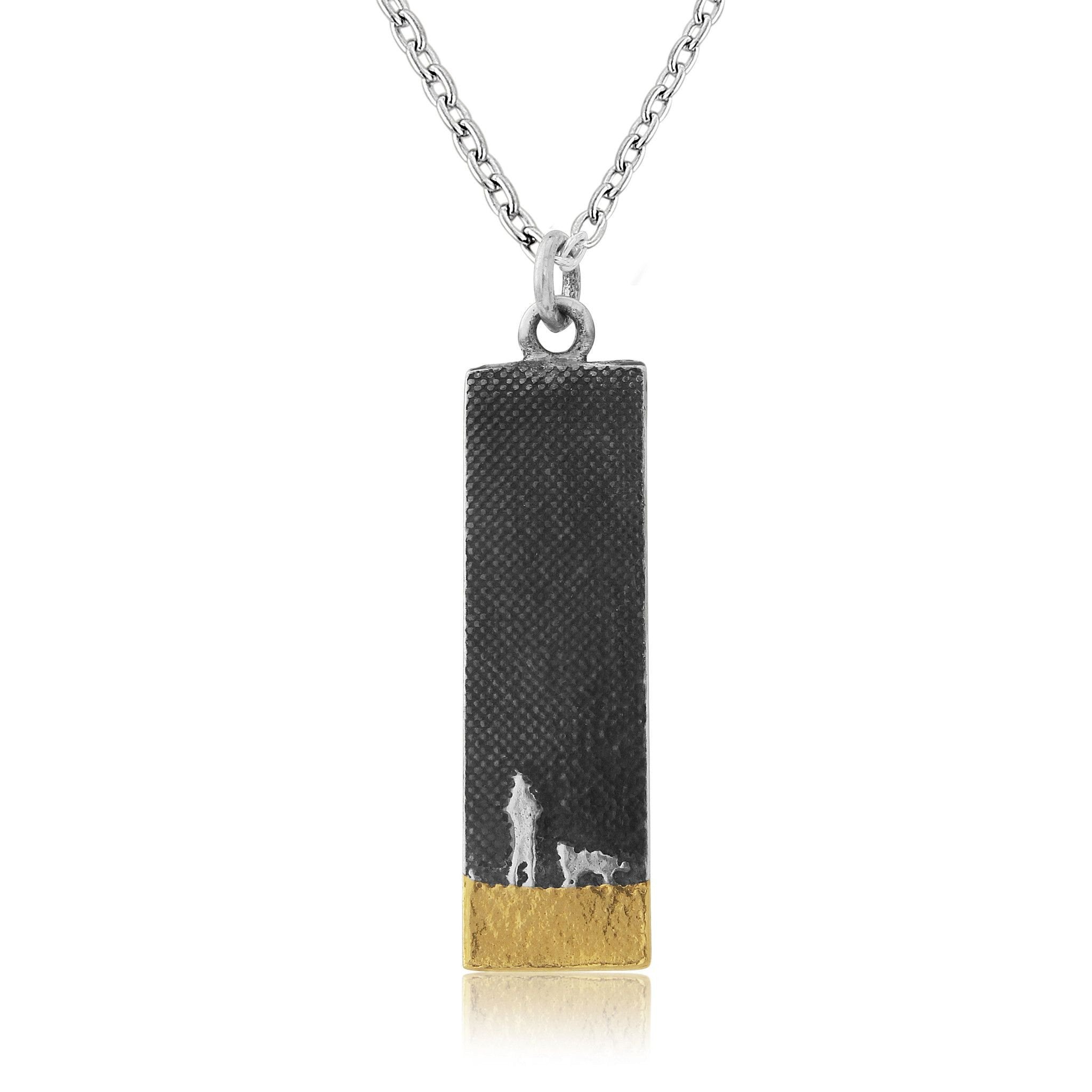 Sterling silver rectangular dog lovers necklace showing two figures walking with their dog beneath a night sky on the beach.