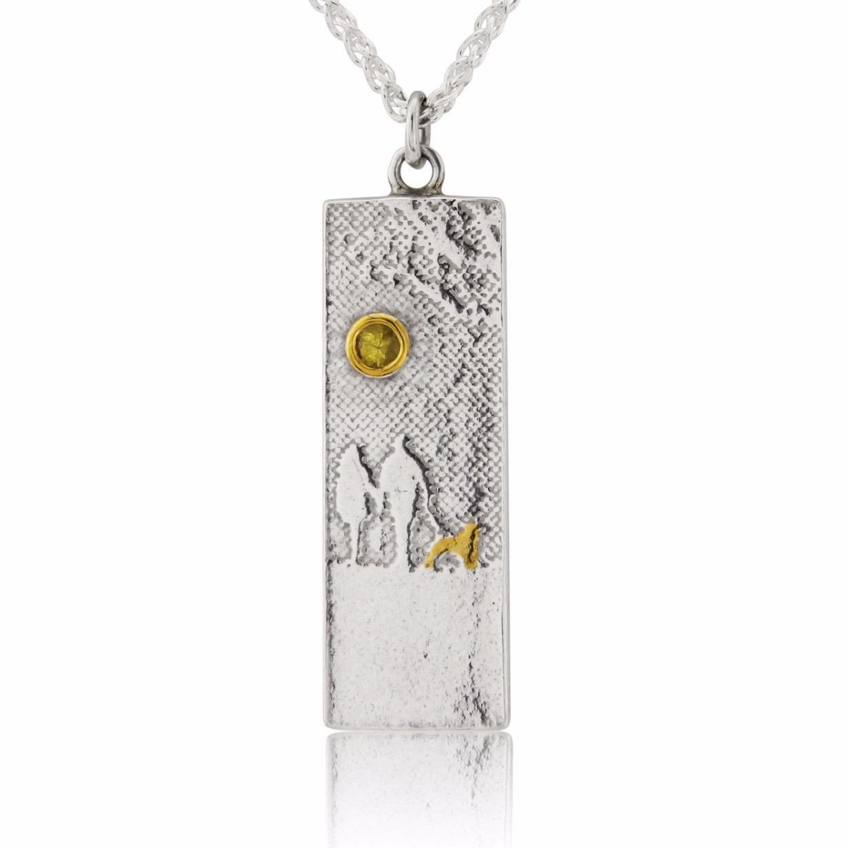 Dog lovers necklace showing a couple and their dog in silhouette beneath a yellow sapphire sun.
