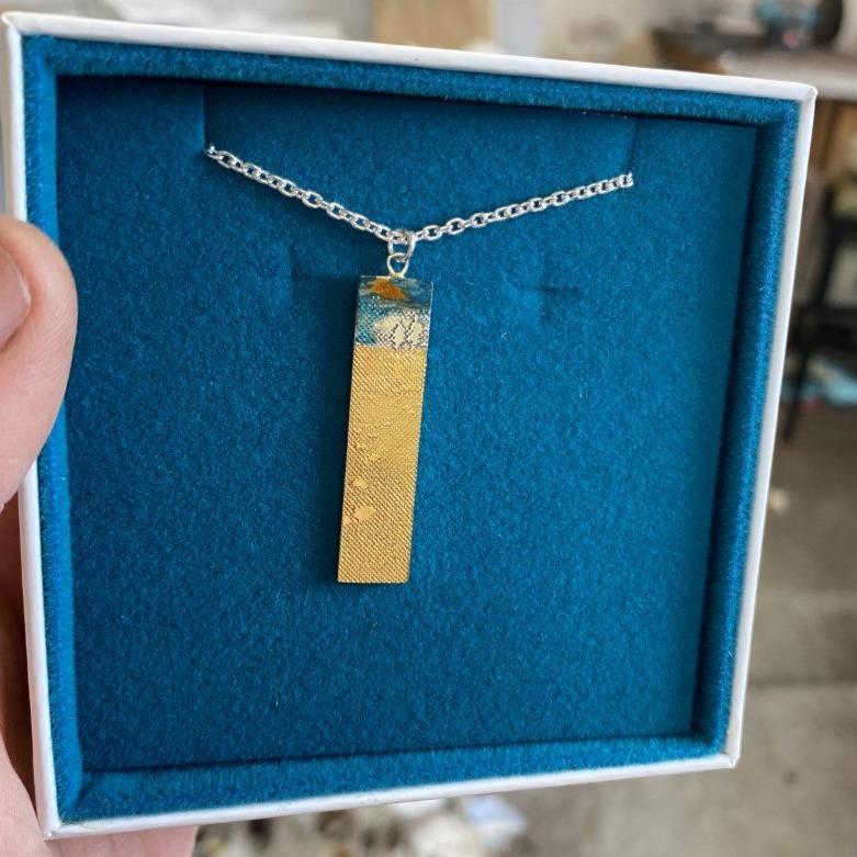 Sterling Silver Footprints in the Sand Necklace with Golden Details and Blue Sky