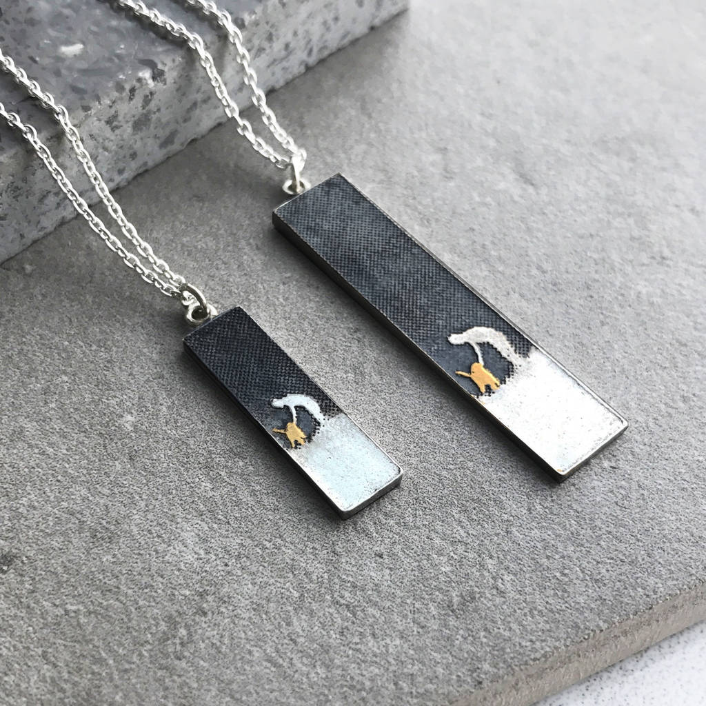 Layflat image showing the small and large Gold Dog Lovers Night Sky Necklaces, each with a rectangular pendant featuring an etched owner and dog beneath an oxidised night sky and a 22ct gold vermeil dog.