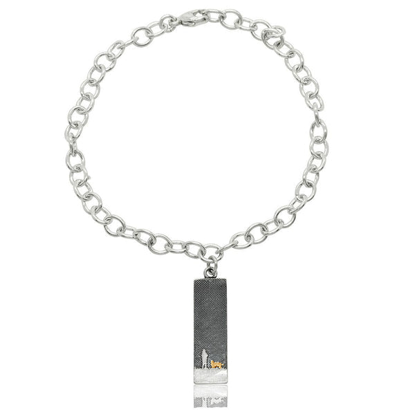 Sterling silver bracelet with a moonlit sky charm showing an owner and their dog, highlighted with a golden dog detail.
