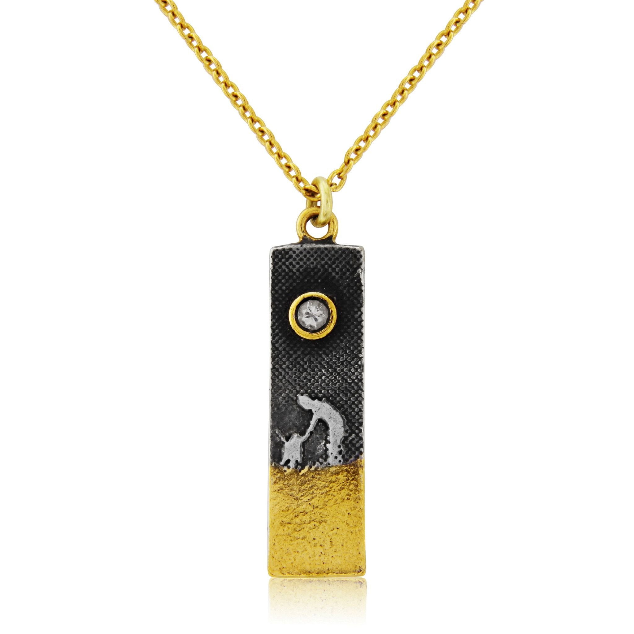 Rectangular sterling silver dog lovers necklace featuring an etched owner and dog walking along the beach, with a sapphire moon and 22ct gold vermeil sand detail.