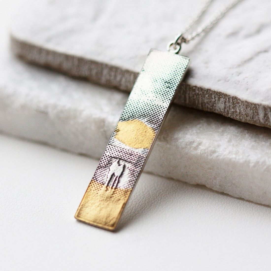 Lifestyle image of the Sunset Couple Memory Necklace displayed on a natural background.