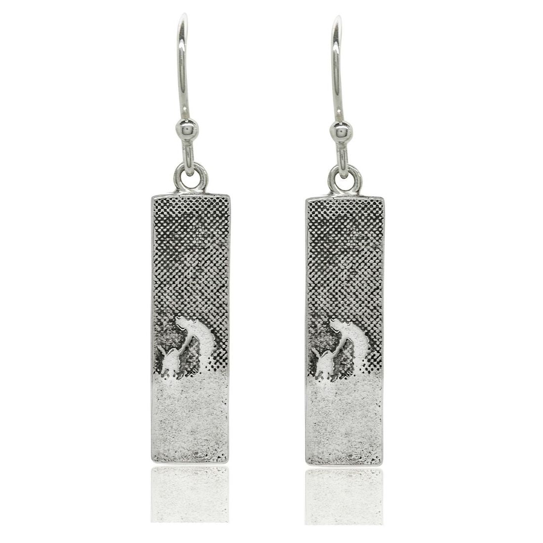 Sterling silver drop earrings etched with a dog and owner sharing a moment of affection.