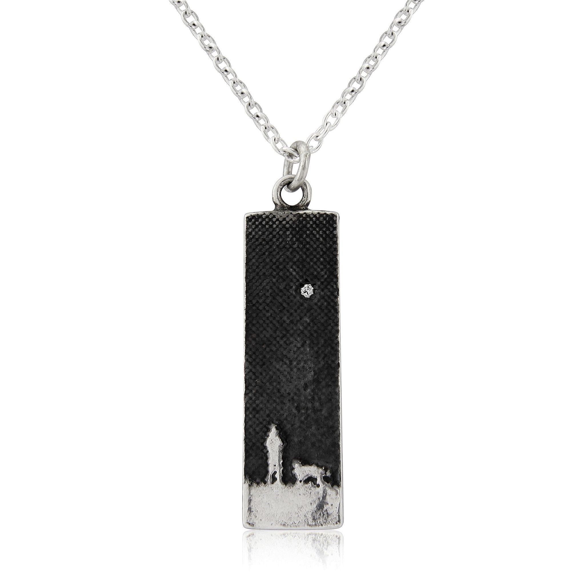 Small sterling silver dog necklace showing an owner and dog under the moonlit sky with a diamond star detail.